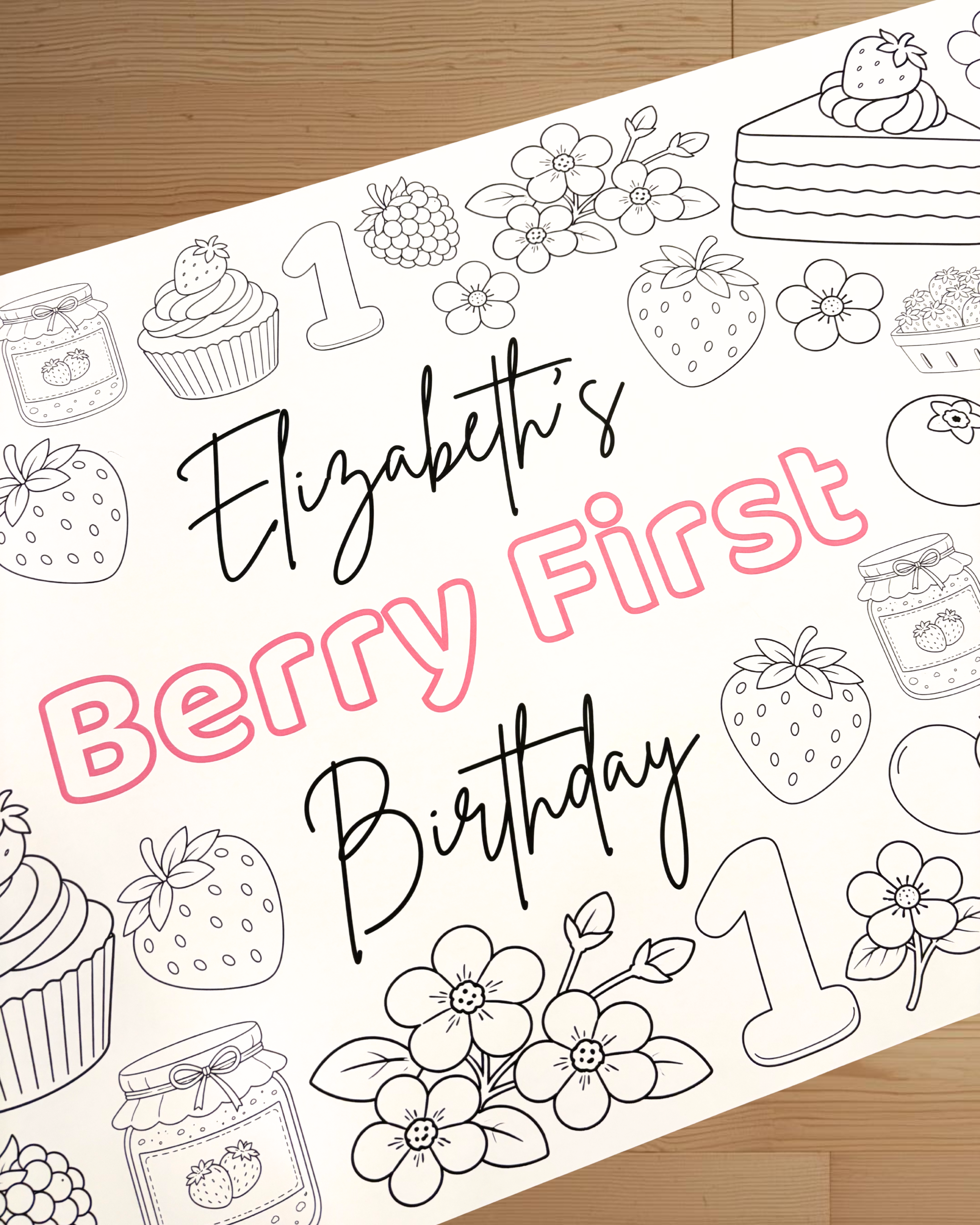 Coloring sheet with 'Elizabeth's Berry First Birthday' text and berry-themed illustrations on a wooden surface.
