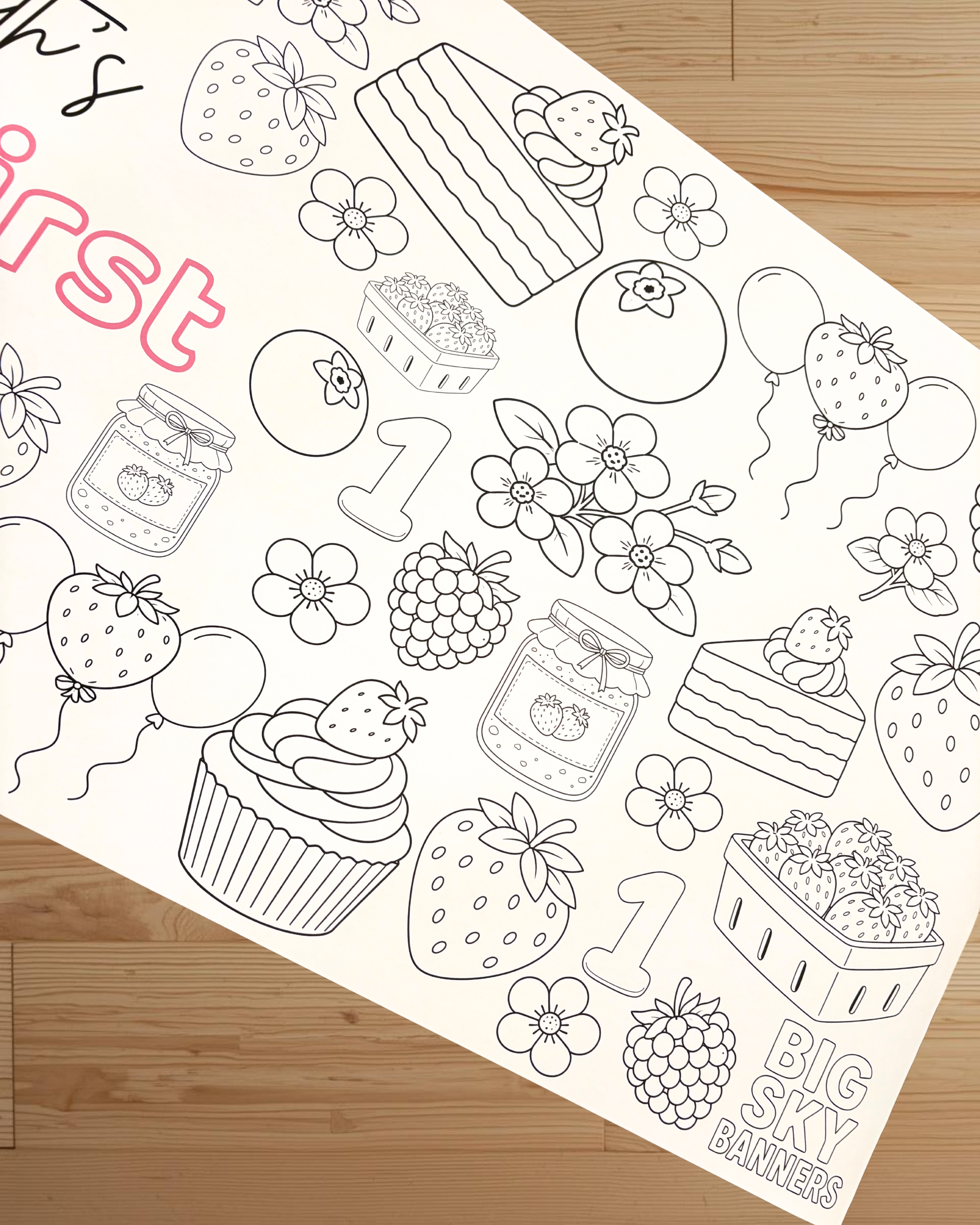 Coloring sheet with black line art on a wooden surface