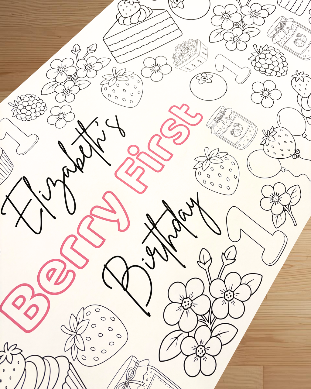 Coloring page with 'Elizabeth's Berry First Birthday' text and berry-themed illustrations on a wooden surface.